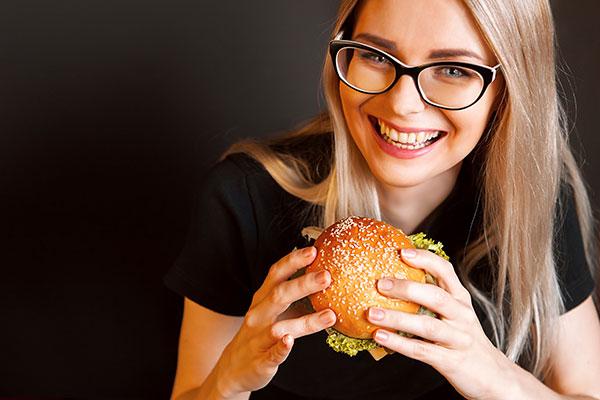 Female student eating a hamburger